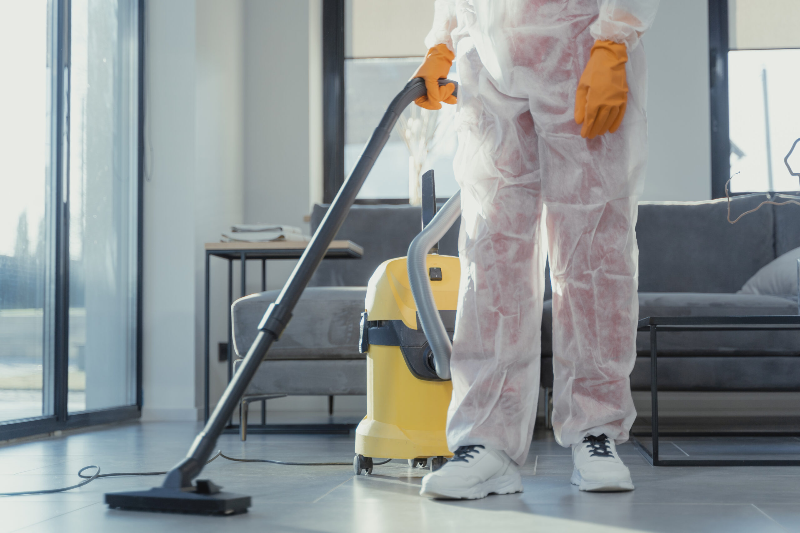 A close up shot of a person using a vacuum cleaner